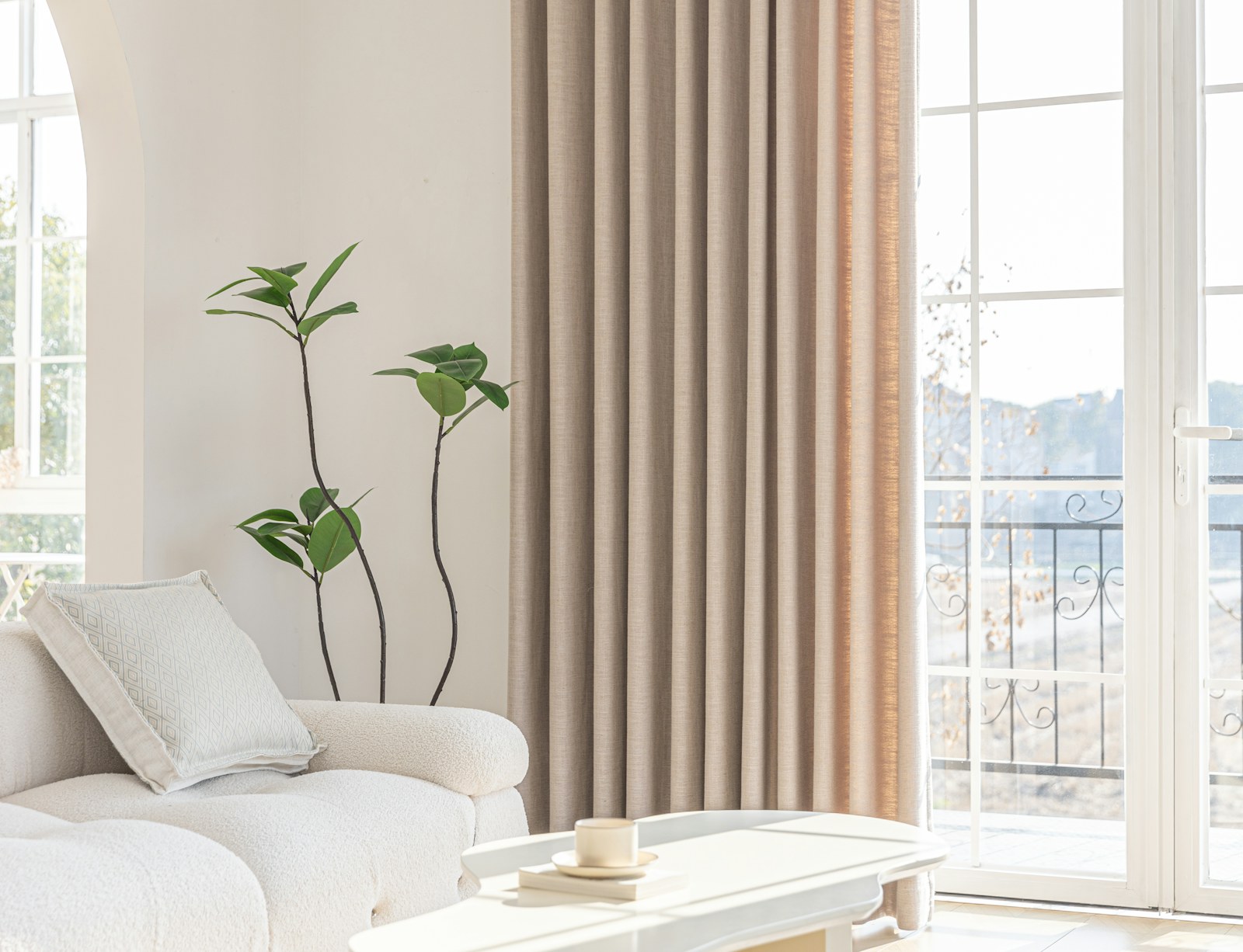 A bright living room with neutral curtains