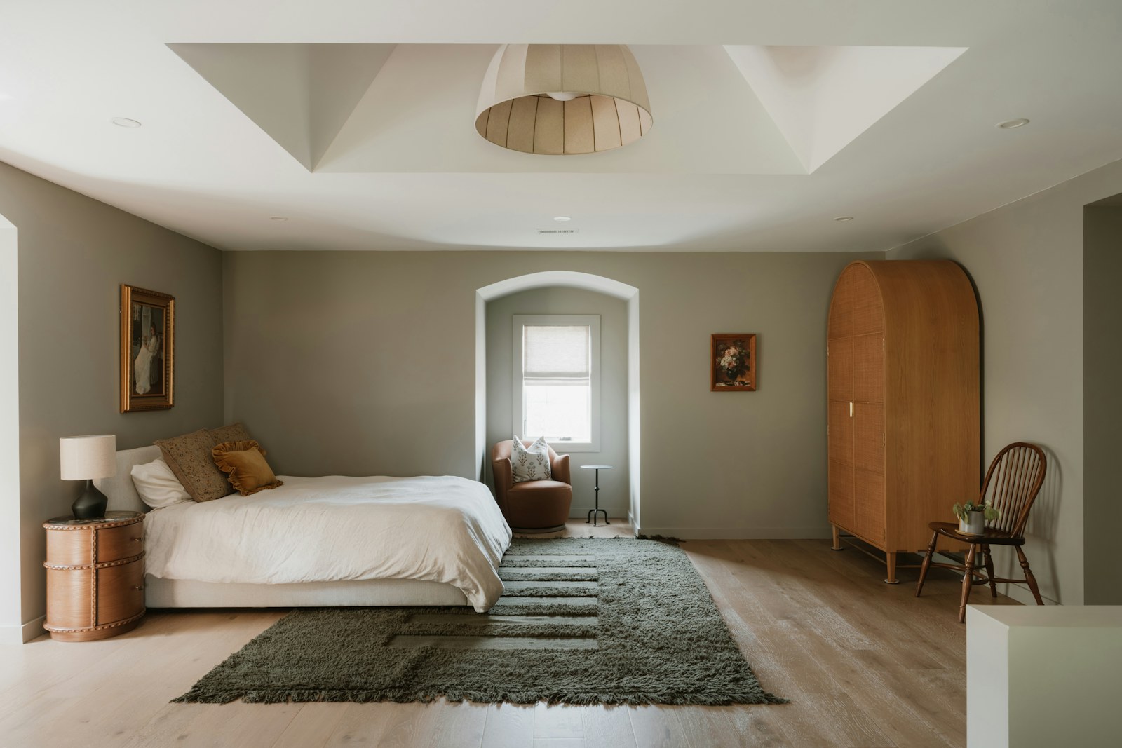 A calm bedroom with warm neutral finishes